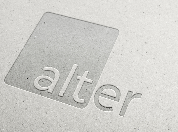 The Alter logo embossed in white paper.